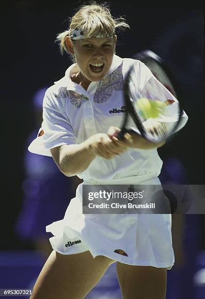 Anke Huber of Germany makes a double backhand return against Leila Meskhi during the Women's Singles first round match of the Australian Open tennis...