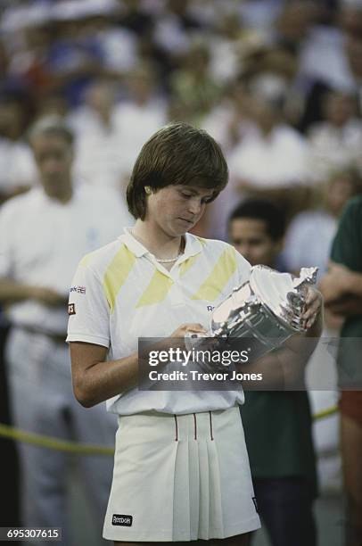 Hana Mandlíková of Czechoslovakia looks down at the trophy after defeating Martina Navratilova to win the Women's Singles Final match of the United...