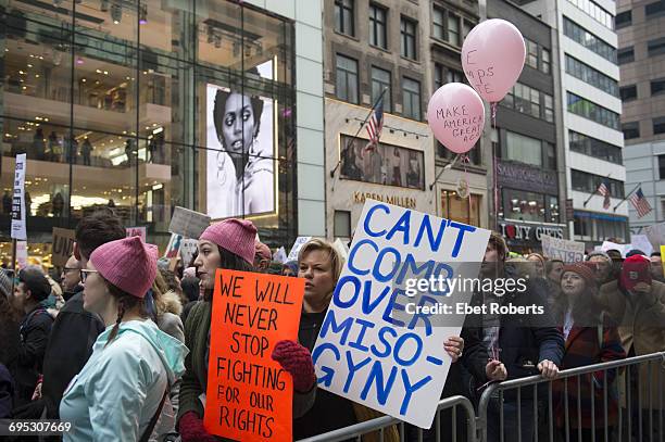 Participants at the Women's March in New York City on January 21, 2017. The placard at centre refers to US President Donald Trump and reads: 'Can't...