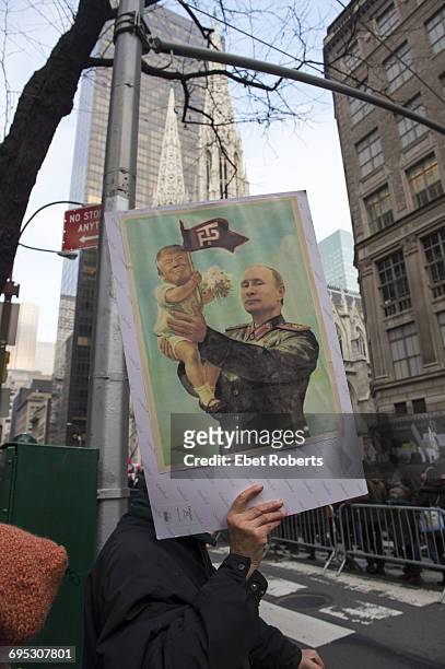 Placard depicting US President Donald Trump as Russian President Vladimir Putin's baby, at the Women's March in New York City, 21st January 2017.