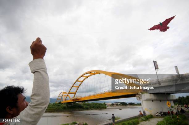 Residents flew kites in the park at Palu IV Bridge while fasting during Ramadan on June 12, 2017 in Palu, Indonesia. Muslims around the world...