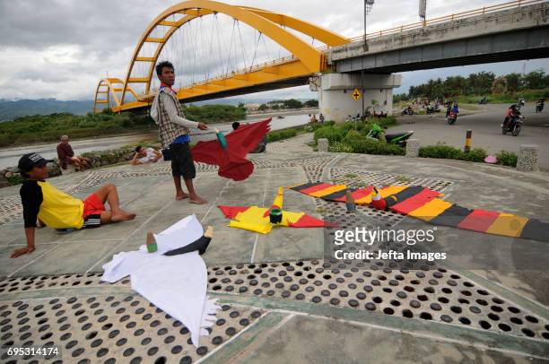 Residents flew kites in the park at Palu IV Bridge while fasting during Ramadan on June 12, 2017 in Palu, Indonesia. Muslims around the world...