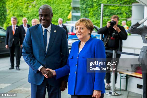 German Chancellor Angela Merkel greets Africa Union chairperson Moussa Faki upon his arrival at the Chancellery in Berlin, Germany on June 12, 2017....