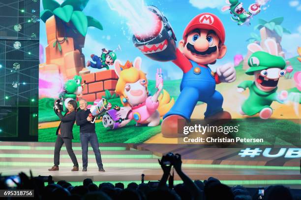 Nintendo co-Representative Director and Creative Fellow Shigeru Miyamoto and Ubisoft Co-founder and CEO Yves Guillemot pose together on stage during...