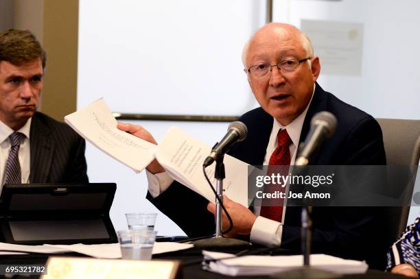 Former U.S. Sen. Ken Salazar, a partner at the law firm WilmerHale, showing two reports on the incident before University of Colorado President Bruce...