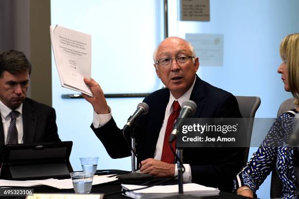 Former U.S. Sen. Ken Salazar, a partner at the law firm WilmerHale, showing two reports on the incident before University of Colorado President Bruce...