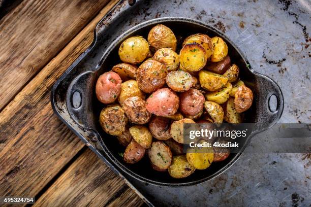 pan fried yukon gold potatoes with herb in cast iron - yukon gold stock pictures, royalty-free photos & images