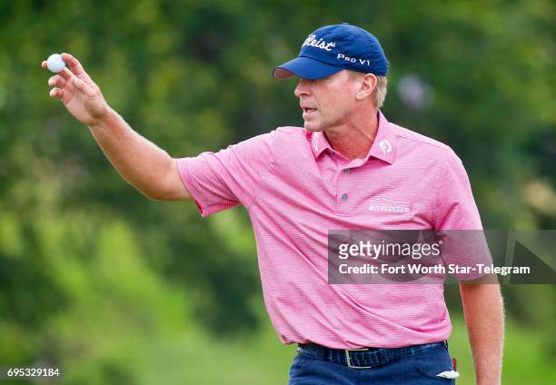 Steve Stricker waves to the crowd on the 18th green during the final round of the Dean & DeLuca Invitational on May 28 at Colonial Country Club in...