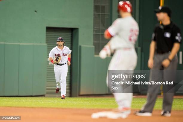 Andrew Benintendi of the Boston Red Sox jogs towards the dugout after throwing out Daniel Nava of the Philadelphia Phillies in the fourth inning at...