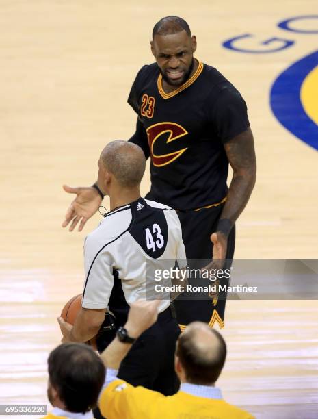 LeBron James of the Cleveland Cavaliers reacts after being called for a foul by against the Golden State Warriors by referee Dan Crawford in Game 5...