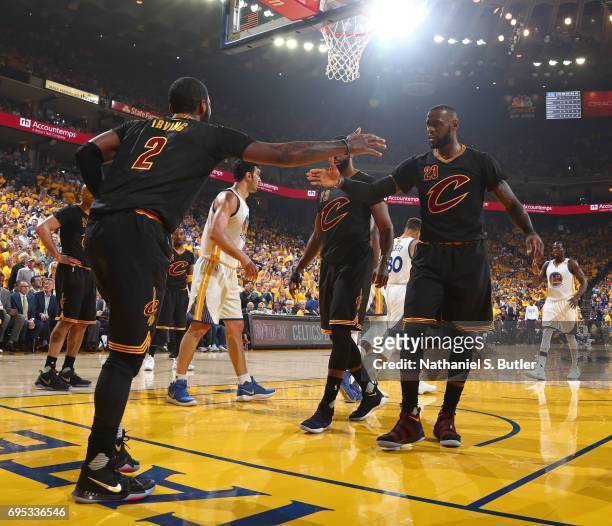 Kyrie Irving and LeBron James of the Cleveland Cavaliers shake hands in Game Five of the 2017 NBA Finals against the Golden State Warriors on June...