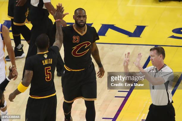 LeBron James and JR Smith of the Cleveland Cavaliers react to a play in Game 5 of the 2017 NBA Finals against the Golden State Warriors at ORACLE...