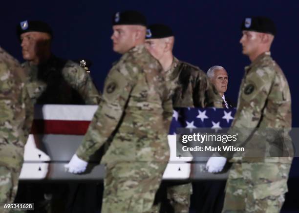 Vice President Mike Pence watches a U.S. Army carry team moves the transfer case containing the remains of U.S. Army Cpl. Dillion C. Baldridge during...