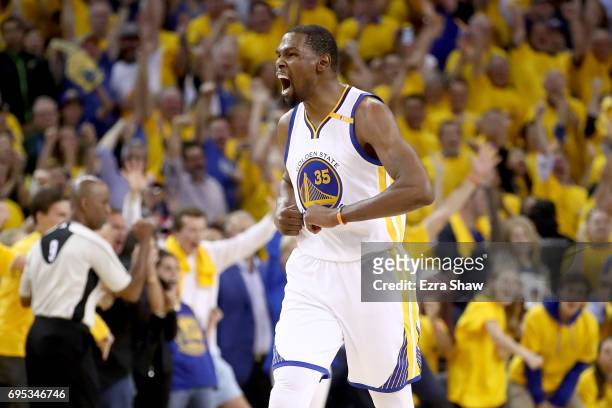 Kevin Durant of the Golden State Warriors reacts after a basket by Stephen Curry in Game 5 of the 2017 NBA Finals at ORACLE Arena on June 12, 2017 in...