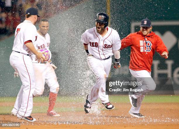 Dustin Pedroia of the Boston Red Sox celebrates his game-winning hit to give the Red Sox a 6-5 win in eleven innings against the Philadelphia...