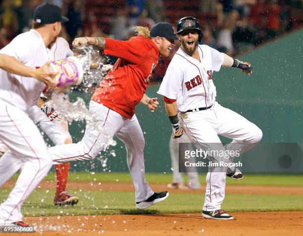 Dustin Pedroia of the Boston Red Sox celebrates his game-winning hit to give the Red Sox a 6-5 win in eleven innings against the Philadelphia...
