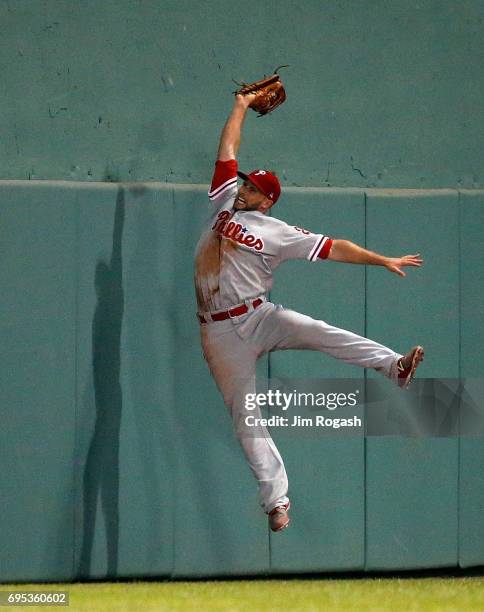 Daniel Nava of the Philadelphia Phillies makes leaping catch on a ball hit by Jackie Bradley Jr. #19 of the Boston Red Sox in the tenth inning at...