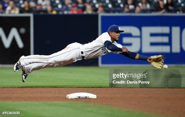 Allen Cordoba of the San Diego Padres dives but can't make the catch on a single hit by Scott Schebler of the Cincinnati Reds during the seventh...
