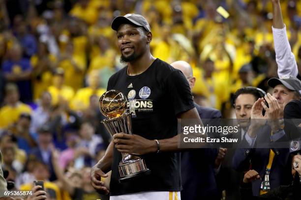 Kevin Durant of the Golden State Warriors celebrates after being named Bill Russell NBA Finals Most Valuable Player after defeating the Cleveland...