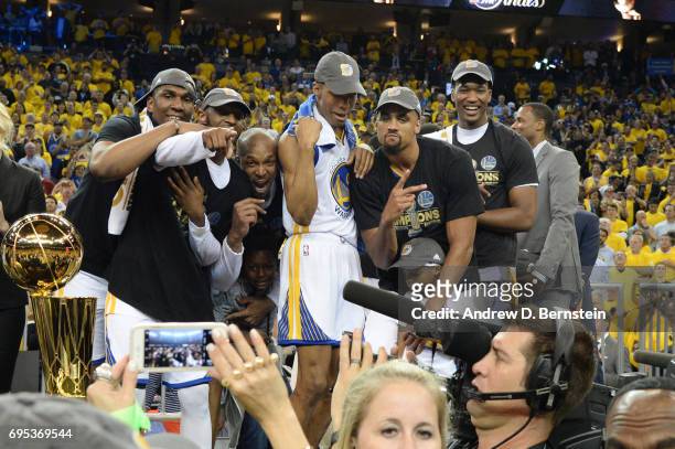 James Michael McAdoo, Patrick McCaw, Ian Clark, and David West of the Golden State Warriors celebrate after winning the 2017 NBA Finals on June 12,...