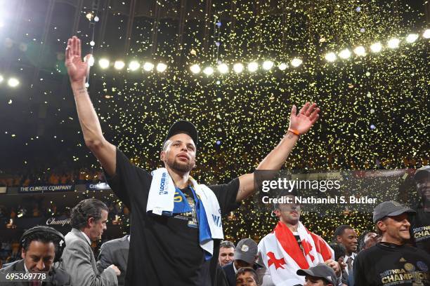 Stephen Curry of the Golden State Warriors holds his arms in the air and celebrates after winning Game Five of the 2017 NBA Finals against the...