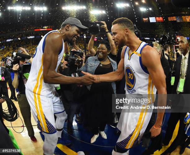 Kevin Durant and Stephen Curry of the Golden State Warriors celebrate after winning the 2017 NBA Finals on June 12, 2017 at ORACLE Arena in Oakland,...