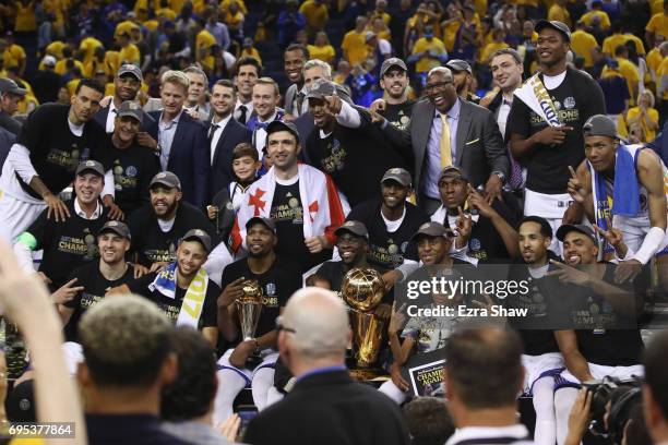 The Golden State Warriors celebrate with the Larry O'Brien Championship Trophy after defeating the Cleveland Cavaliers 129-120 in Game 5 to win the...