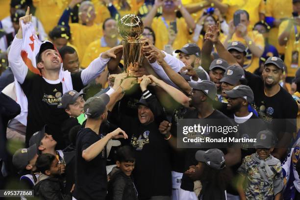 The Golden State Warriors celebrate with the Larry O'Brien Championship Trophy after defeating the Cleveland Cavaliers 129-120 in Game 5 to win the...