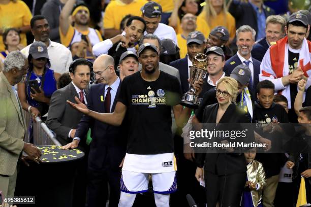 Kevin Durant of the Golden State Warriors celebrates with the Bill Russell NBA Finals Most Valuable Player Award after defeating the Cleveland...