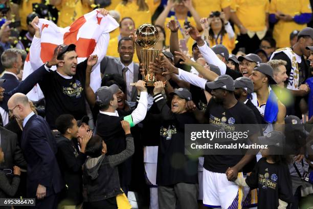 The Golden State Warriors celebrate with the Larry O'Brien Championship Trophy after defeating the Cleveland Cavaliers 129-120 in Game 5 to win the...