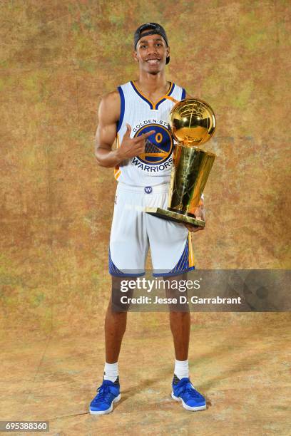 Patrick McCaw of the Golden State Warriors poses for a portrait with the Larry O'Brien Trophy after defeating the Cleveland Cavaliers in Game Five of...