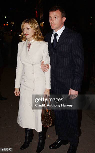 Singer and actress Madonna and her husband and film director Guy Ritchie arrive at the opening of the Mario Testino photography exhibition January...