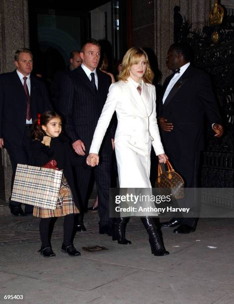 Singer and actress Madonna and her husband and film director Guy Ritchie arrive with their daughter Lourdes at the opening of the Mario Testino...