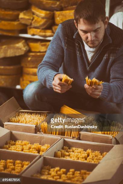 packager packing church candles for order delivery. - bank check processing stock pictures, royalty-free photos & images