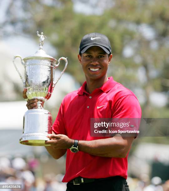 Tiger Woods poses with the winner's trophy after winning the 108th US Open Championship at Torrey Pines South Golf Course in San Diego, CA.