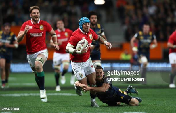Jack Nowell of the Lions is tackled by Kayne Hammington of the Highlanders during the 2017 British & Irish Lions tour match between the Highlanders...
