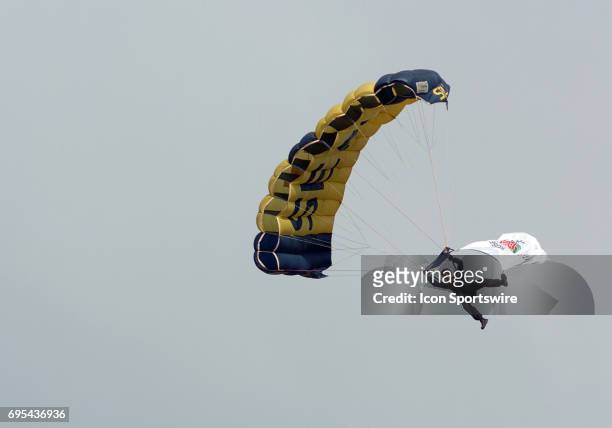 Military skydiver drops from the sky with the Rose Bowl flag during the Rose Bowl game featuring the University of Illinois Fighting Illini against...
