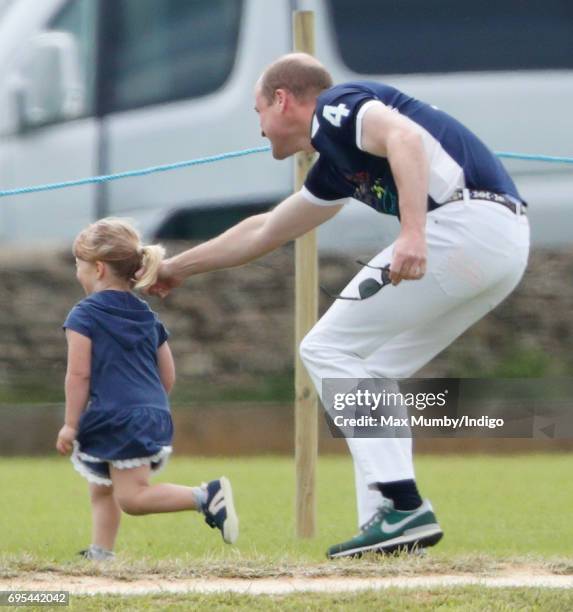 Prince William, Duke of Cambridge plays chase with Mia Tindall as they attend the Maserati Royal Charity Polo Trophy Match during the Gloucestershire...