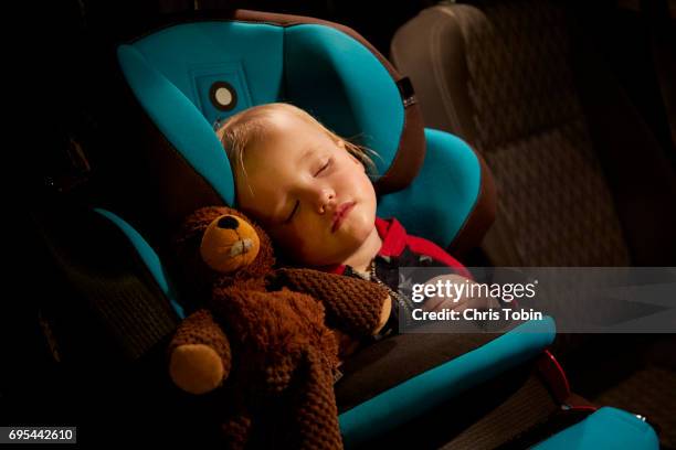 toddler asleep in car seat with stuffed animal - boy with car stock-fotos und bilder