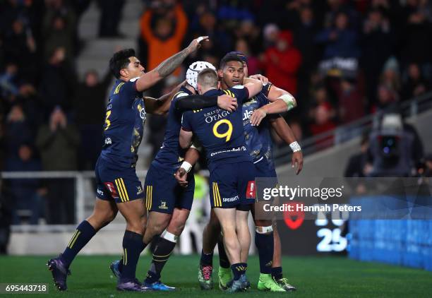 Waisake Naholo of the Highlanders celebrates with teammates after scoring the opening try during the 2017 British & Irish Lions tour match between...