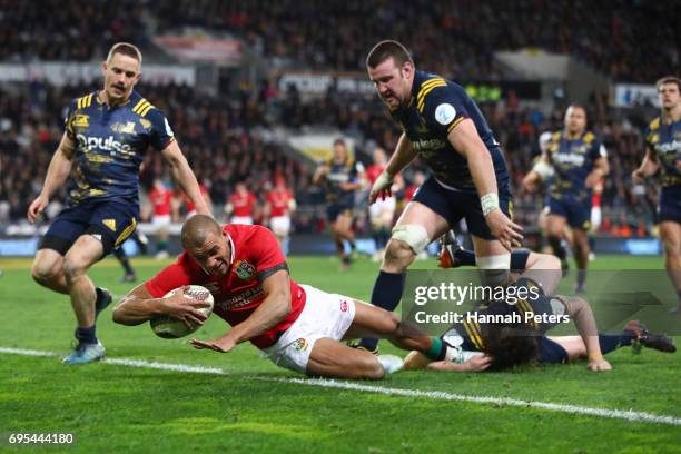 Jonathan Joseph of the Lions dives over to score his team's first try during the 2017 British & Irish Lions tour match between the Highlanders and...