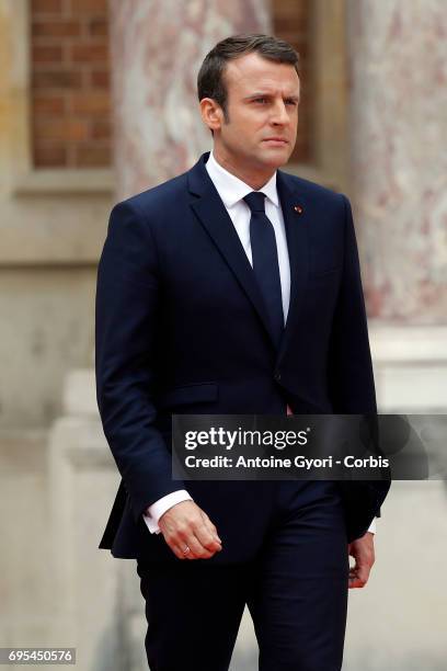 French President Emmanuel Macron wallks on the red carpet to welcome Russian President Vladimir Putin prior to their meeting at 'Chateau de...