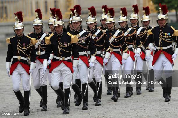 The Republican Guard arrives in the courtyard of the Versailles Palace to welcome French President Emmanuel Macron and Russian President Vladimir...