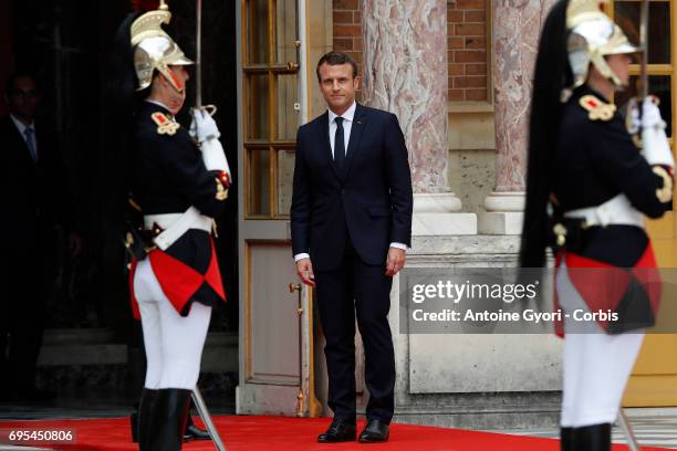 French President Emmanuel Macron wallks on the red carpet to welcome Russian President Vladimir Putin prior to their meeting at 'Chateau de...