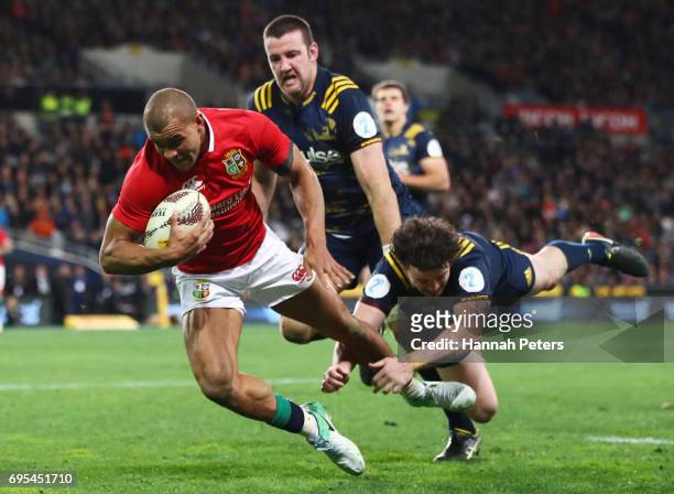 Jonathan Joseph of the Lions dives over to score his team's first try during the 2017 British & Irish Lions tour match between the Highlanders and...