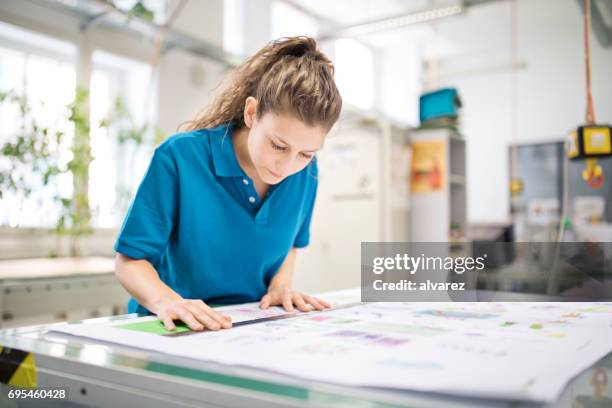 woman designer working at printing factory - printing press stock pictures, royalty-free photos & images