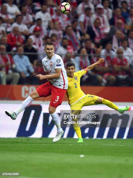 Artur Jedrzejczyk of Poland and Romario Benzar of Romania in action during the 2018 FIFA World Cup Russia eliminations match between Poland and...