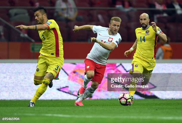 Alin Tosca of Romania, Jakub Blaszczykowski of Poland and Iasmin Latovlevici of Romania in action during the 2018 FIFA World Cup Russia eliminations...