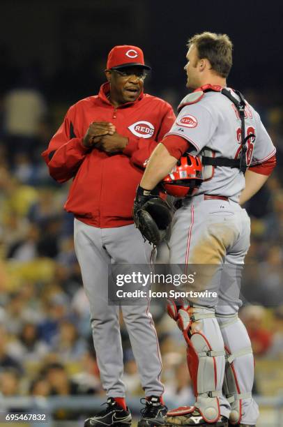 Red Manager Dusty Baker talks with Reds David Ross on the mound during a Major League Baseball game between the Los Angeles Dodgers and the...