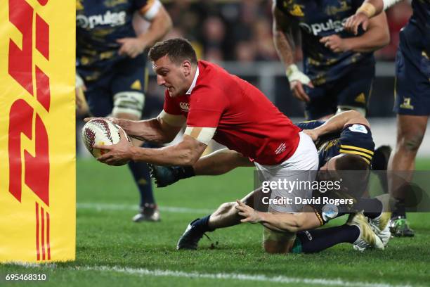 Sam Warburton of the Lions drives through the tackle from Kayne Hammington of the Highlanders to score his team's third try during the 2017 British &...